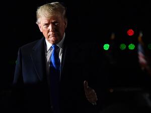 US President Donald Trump gestures after disembarking from Air Force One after landing at Stansted Airport, northeast of London on December 2, 2019 (AFP/ File Photo)