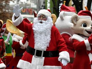 A performer clad in Santa Claus outfits poses during a street event to promote Christmas season at a shopping district in Seoul on December 3, 2019. (AFP/ File Photo)