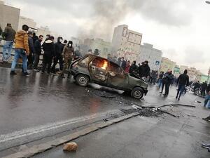 Iranian protesters gather around a burning car during a demonstration against an increase in gasoline prices in the capital Tehran, on November 16, 2019. (AFP/File)