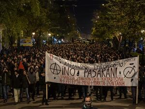People carry a giant banner reading "They shall not pass" as they march in central Athens on December 6, 2019 after a rally commemorating the death of a 15-year-old teenager, who was fatally shot by a police officer in 2008. (AFP/ File Photo)