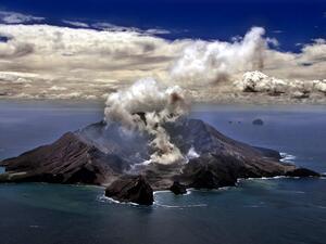 This file photo taken on November 29, 1999 shows New Zealand's most active volcano on White Island in the Bay of Plenty giving off dense plumes of steam and gas. New Zealand's White Island volcano erupted suddenly on December 9, 2019, prompting fears for a group of visitors seen walking on the crater floor moments before. TORSTEN BLACKWOOD / AFP