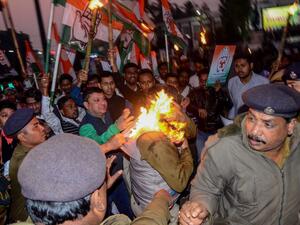 Police personnel try to rescue a police officer (C) caught on fire during a protest against the government's Citizenship Amendment Bill (CAB) in Agartala, the capital of India's northeastern state of Tripura on December 11, 2019. (AFP/ File Photo)