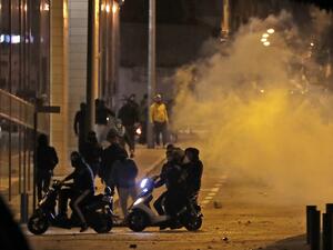 Supporters of Lebanon's Shiite Hezbollah and Amal groups clash with riot police as they were heading to the area where anti-government protests were taking place early on December 12, 2019 in central Beirut. ANWAR AMRO / AFP