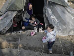 A syrian woman sits in her tent with her children in the Vial refugee camp, on the Greek island of Chios, on December 10, 2019.  (AFP/ File Photo)