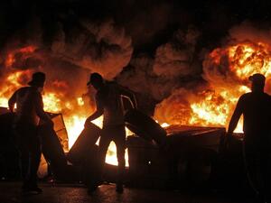 Protesters set aflame dumpsters and tires as they block a road in the southern Lebanese city of Sidon early on December 17, 2019. Mahmoud ZAYYAT / AFP