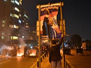 A Lebanese man fixes a poster bearing the picture of outgoing prime minister Saad Hariri as his supporters block a road in the Qasqas neighbourhood of the capital Beirut, on December 19, 2019, to denounce the nomination of Prime Minister-designate Hassan Diab. Crisis-hit Lebanon's president named today former minister Hassan Diab, backed by Shiite movement Hezbollah, as the country's new prime minister. The little-known 60-year-old engineering professor at the American University of Beirut(AUB) replaces out