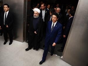 ranian President Hassan Rouhani (L) walks with Japanese Prime Minister Shinzo Abe (R) to a meeting room at the prime minister's office in Tokyo on December 20, 2019. Charly TRIBALLEAU / POOL / AFP
