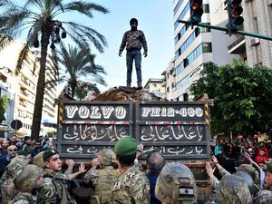 A supporter of outgoing Lebanese premier Saad Hariri stands atop a truckload of dirt during a protest in Beirut's Corniche al-Mazraa neighbourhood on December 20, 2019. Anger was fuelled among members of Lebanon's Sunni community who said the prime-minister-designate did not enjoy the sect's backing for a post reserved for Sunni Muslims by a power-sharing system enshrined after the end of the 1975-1990 civil war. STR / AFP
