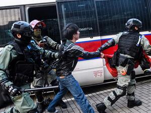 Police detain a man during a rally in Hong Kong on December 22, 2019 to show support for the Uighur minority in China. Hong Kong riot police broke up a solidarity rally for China's Uighurs on December 22 -- with one officer drawing a pistol -- as the city's pro-democracy movement likened their plight to that of the oppressed Muslim minority. Anthony WALLACE / AFP