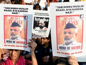Protesters hold placards during a demonstration held against India's new citizenship law at the Town Hall in Bangalore on December 22, 2019. Prime Minister Narendra Modi sought on December 22 to reassure India's Muslims as a wave of deadly protests against a new citizenship law put his Hindu nationalist government under pressure like never before. Manjunath Kiran / AFP