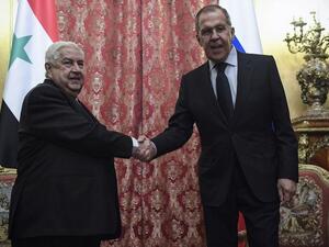 Russian Foreign Minister Sergey Lavrov (R) shakes hands with his Syrian counterpart Walid Muallem during their meeting in Moscow on December 23, 2019. Alexander NEMENOV / AFP