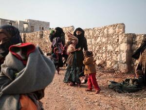 Displaced Syrians from the south of Idlib province queue to receive food aid from a truck in the countryside west of the town of Dana in the northwestern Syrian region on December 23, 2019. Aaref WATAD / AFP