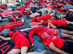 Activists lie on the ground in the Chilean capital and hold hands in solidarity against social and economic inequality affecting women  (AFP)