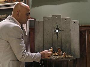 The piece has appeared in the Walled Off Hotel, Banksy's property which overlooks the border wall in the divided city (AFP)