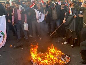 Protesters set fire to the outside walls of the US Embassy in Baghdad (Twitter)