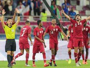 Qatar players cheer as Japanese referee Ryuji Sato signals the end of the 24th Arabian Gulf Cup Group A football match between Qatar and the United Arab Emirates at the Khalifa International Stadium in the Qatari capital Doha on December 2, 2019. KARIM JAAFAR / AFP