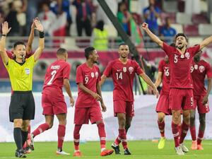 Qatar players cheer as Japanese referee Ryuji Sato signals the end of the 24th Arabian Gulf Cup Group A football match between Qatar and the United Arab Emirates at the Khalifa International Stadium in the Qatari capital Doha on December 2, 2019. KARIM JAAFAR / AFP