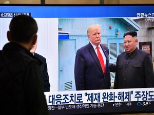 A man watches a television news programme showing file footage of a meeting between US President Donald Trump and North Korean leader Kim Jong Un at the truce village of Panmunjom, at a railway station in Seoul on January 1, 2020. North Korean leader Kim Jong Un has declared an end to its moratoriums on nuclear and intercontinental ballistic missile tests and threatened a demonstration of a "new strategic weapon" soon. Jung Yeon-je / AFP