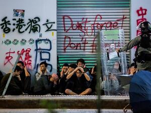 Police detain a group of people after a pro-democracy march in Hong Kong on January 1, 2020. Tens of thousands of protesters marched in Hong Kong during a massive pro-democracy rally on New Year's Day, looking to carry the momentum of their movement into 2020.  ISAAC LAWRENCE / AFP