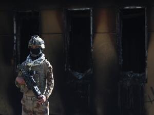 A member of Iraq's security forces stands guard in front of the US embassy in the capital Baghdad, after an order from the Hashed al-Shaabi paramilitary force to supporters to leave the compound on January 1, 2020. #FGU89 Thousands of Iraqi supporters of the largely Iranian-trained Hashed had encircled and vandalised the embassy compound yesterday, outraged by US air strikes that killed 25 fighters of the military network over the weekend. AHMAD AL-RUBAYE / AFP