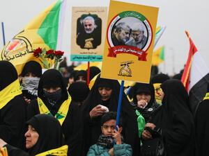 Supporters of the Hashed al-Shaabi paramilitary force and Iraq's Hezbollah brigades attend the funeral of Iranian military commander Qasem Soleimani (portrait) and Iraqi paramilitary chief Abu Mahdi al-Muhandis (portrait) in Baghdad's district of al-Jadriya, in Baghdad's high-security Green Zone, on January 4, 2020.(AFP/ File Photo)