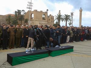 Libyan mourners pray by the coffins of army cadets, who were killed in an air strike on a military school, during their funeral in the Libyan capital Tripoli on January 5, 2020. (AFP/ File Photo)