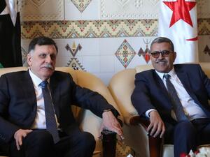 Algeria's Prime Minister Abdelaziz Djerad (R) meets with Libya's UN-recognised Prime Minister Fayez al-Sarraj upon his arrival in Algiers on January 6, 2020 for talks on the Libyan crisis. (AFP/ File Photo)