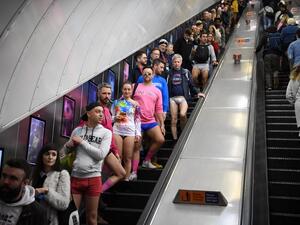 People use an escalator as they take part in the annual 'No Trousers On The Tube Day' (No Pants Subway Ride) on the London Underground in central London on January 12, 2020.  (AFP/ File Photo)