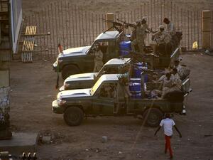 Members of Sudan's intelligence services shoot bullets in the air at the headquarters of the Directorate of General Intelligence Service, in the Riyadh district of the capital Khartoum, on January 14, 2020. Heavy gunfire broke out in Sudanese capital as several agents of the long-feared security agency launched a "rebellion" against a restructuring plan, prompting a closure of the international airport. ASHRAF SHAZLY / AFP