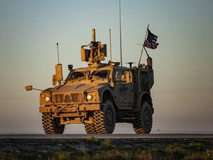 A vehicle part of a US military convoy drives on the outskirts of the Kurdish-controlled northern Syrian city of Qamishli on January 14, 2020. Delil SOULEIMAN / AFP
