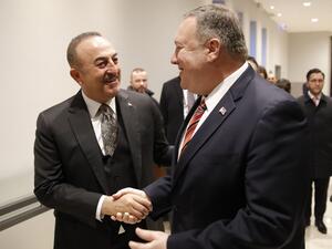 Turkish Foreign Minister Mevlut Cavusoglu (L) shakes hands with US Secretary of State Mike Pompeo as they arrive for a bi-lateral meeting prior a Peace summit on Libya in Berlin on January 19, 2020. AFP