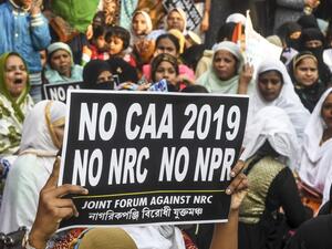 Protesters hold placards as they take part in a demonstration against India's new citizenship law, in Kolkata on January 21, 2020. Dibyangshu SARKAR / AFP