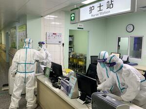 This photo taken on January 22, 2020 shows medical staff members wearing protective suits at the Zhongnan hospital in Wuhan in China's central Hubei province. China banned trains and planes from leaving Wuhan at the centre of a virus outbreak on January 23. (AFP/ File Photo)