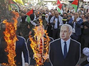 In this file photo taken on November 26, 2019, Palestinian protesters burn cardboard cutouts of US President Donald Trump, State Secretary Mike Pompeo, and Israeli Prime Minister Benjamin Netanyahu, during a demonstration in the center of Nablus in the occupied West Bank. (AFP/ File Photo)