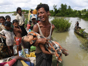 A Rohingya refugee reacts while holding his dead son after crossing the Naf river from Myanmar into Bangladesh in Whaikhyang on Oct. 9, 2017. (Indranil Mukherjee/AFP/Getty Images)