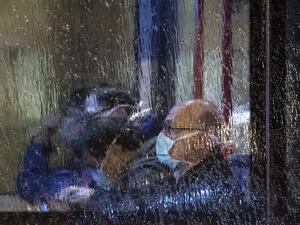 People, wearing masks, are seen through the window of a bus with on board German and foreign nationals evacuated from the Chinese city of Wuhan, the epicentre of the coronavirus outbreak, as the bus leaves Frankfurt am Main's airport to make its way to a military base in Germersheim on February 1, 2020. The passengers were to be examined for symptoms of the virus, which has killed 259 people in China so far, at a specially equipped facility at the airport before being held in quarantine for two weeks at a m