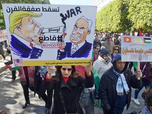 Tunisian demonstrators hold up placards against US President Donald Trump's Middle East peace plan proposal during a protest on February 5, 2020 in Tunis. Arabic writing on placards reads: "Jerusalem is the capital of Palestine" (R) and "Down with the 'Deal of the Century', #Boycott" next to cartoon images of Trump and Israel's Prime Minister Benjamin Netanyahu. FETHI BELAID / AFP