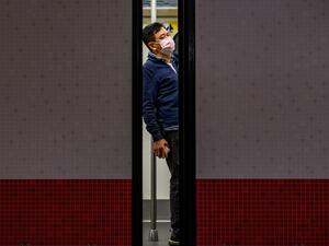 A man wears a face mask as a preventative measure against the COVID-19 coronavirus, as he stands in a train at Mong Kok MTR station in Hong Kong on February 14, 2020. The death toll from China's virus epidemic neared 1,400 on Friday with six medical workers among the victims, underscoring the country's struggle to contain a deepening health crisis. Philip FONG / AFP