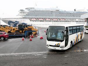 Passengers look out from their balconies on the Diamond Princess cruise ship, which has around 3,600 people quarantined onboard due to fears of the new COVID-19 coronavirus, at the Daikoku Pier Cruise Terminal in Yokohama port on February 16, 2020. The number of people who have tested positive for the new coronavirus on a quarantined ship off Japan's coast has risen to 355, the country's health minister said February 16. Behrouz MEHRI / AFP