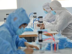 This photo taken on February 18, 2020 shows workers making face masks to satisfy increased demand during China's COVID-19 coronavirus outbreak, at a factory in Nanjing, in China's Jiangsu province. AFP