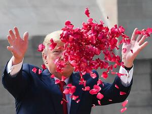 US President Donald Trump sprays rose petals to pay tribute at Raj Ghat, the memorial for Indian independence icon Mahatma Gandhi, in New Delhi on February 25, 2020. Mandel NGAN / AFP