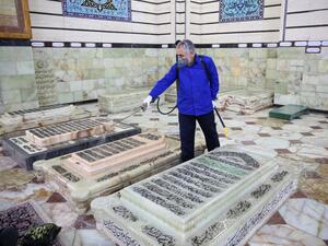 An Iranian sanitary worker disinfects Qom's Masumeh shrine on February 25, 2020 to prevent the spread of the coronavirus which reached Iran, where there were concerns the situation might be worse than officially acknowledged. AFP