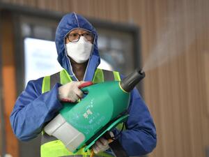 A worker wearing protective gear sprays disinfectant as part of preventive measures against the spread of the COVID-19 coronavirus, at a railway station in Daegu on February 26, 2020. An American soldier stationed in South Korea has tested positive for the COVID-19 coronavirus, commanders said on February 26, as the country's case total jumped again. Meanwhile, South Korean authorities reported 169 new infections, taking the overall national tally to 1,146, by far the largest outside China. Jung Yeon-je / A