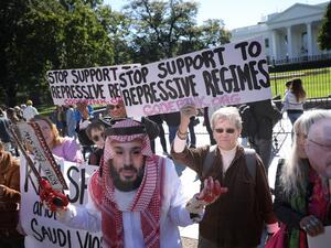 A protester dressed as Saudi Arabian crown prince Mohammad bin Salman, demonstrates with members of the group Code Pink outside the White House in the wake of the disappearance of Saudi Arabian journalist Jamal Khashoggi October 19, 2018 in Washington, DC. Khashoggi has disappeared following a meeting at the Saudi consulate in Istanbul on October 2, 2018. Win McNamee/Getty Images/AFP WIN MCNAMEE / GETTY IMAGES NORTH AMERICA / AFP