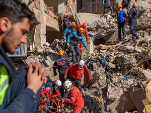 Rescue workers work amid the rubble of a building after an earthquake in Elazıg, eastern Turkey, on Saturday. Photo: Bulent Kilic/AFP via Getty Images
