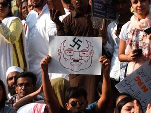 Protesters hold placards during a demonstration against India`s new citizenship law in Mumbai on 27 December, 2019. Photo: AFP