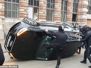 Anti-Macron rioters were caught on camera flipping an Audi on to its roof in Lille before smashing the windscreen. (Twitter)