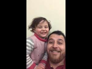 Abdullah Mohammad [R] taught his daughter the 'laughing game' to cope [Screenshot]