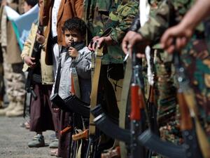 Yemeni children hold automatic rifles as they join grown up relatives in a tribal gathering organised by the Shiite Huthi movement (Picture: MOHAMMED HUWAIS/AFP/Getty Images)