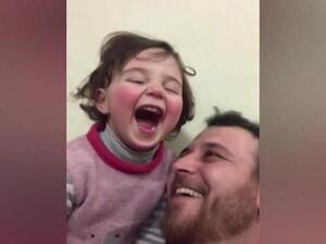 'Laugh at the Fireworks!' Syrian Father Makes Up a Game to Comfort His Daughter as Bombs Fall
